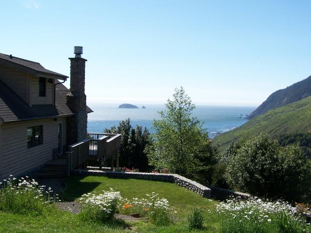 View of the north side of the house with the river rock flower beds,